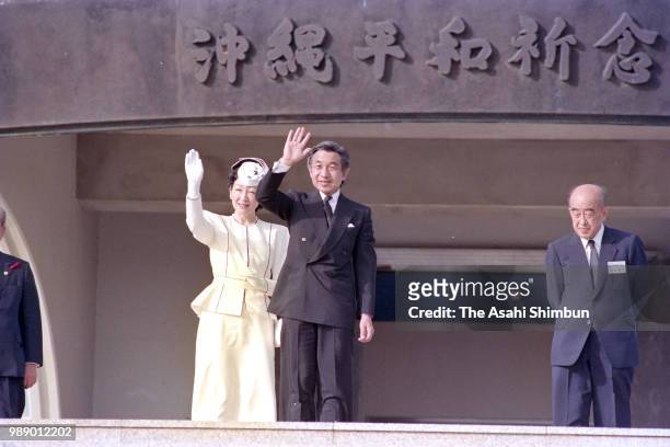 Crown Prince Akihito and Crown Princess Michiko wave to well-wishers in front of the Peace Memorial Hall at Okinawa Peace Memorial Park on October...