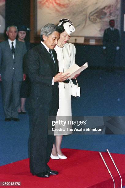 Crown Prince Akihito addresses while Crown Princess Michiko listens during their visit to the Peace Memorial Hall at Okinawa Peace Memorial Park on...