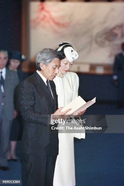 Crown Prince Akihito addresses while Crown Princess Michiko listens during their visit to the Peace Memorial Hall at Okinawa Peace Memorial Park on...