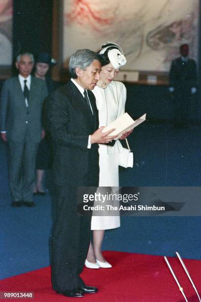 Crown Prince Akihito addresses while Crown Princess Michiko listens during their visit to the Peace Memorial Hall at Okinawa Peace Memorial Park on...