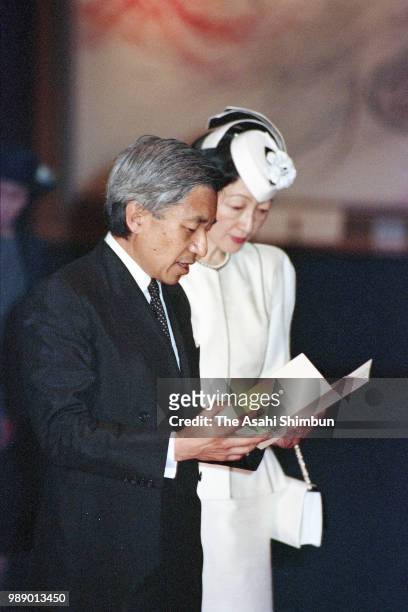 Crown Prince Akihito addresses while Crown Princess Michiko listens during their visit to the Peace Memorial Hall at Okinawa Peace Memorial Park on...