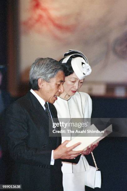 Crown Prince Akihito addresses while Crown Princess Michiko listens during their visit to the Peace Memorial Hall at Okinawa Peace Memorial Park on...