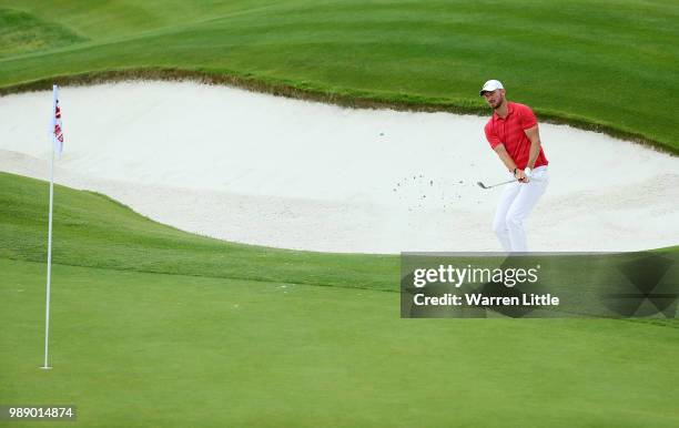 Chris Wood of England plays out of a bunker on the 18th hole during day four of the HNA Open de France at Le Golf National on July 1, 2018 in Paris,...