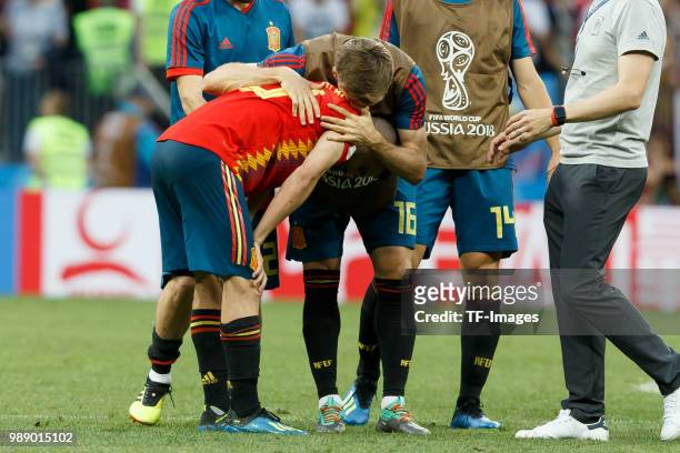 Koke of Spain and Nacho Monreal of Spain look dejected after the 2018 FIFA World Cup Russia match between Spain and Russia at Luzhniki Stadium on...