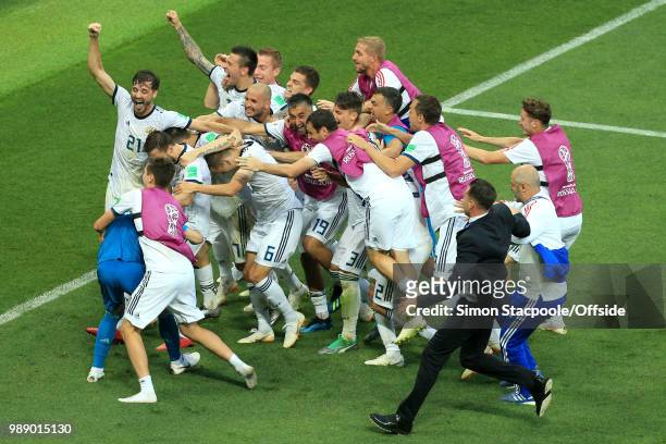 Russia mob Russia goalkeeper Igor Akinfeev after he saves the final penalty and wins them the match during the 2018 FIFA World Cup Russia Round of 16...