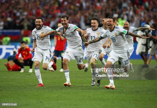 Vladimir Granat , Aleksandr Erokhin, Aleksandr Golovin and Fyodor Smolov of Russia celebrates when they win the penalty shoot out during the 2018...