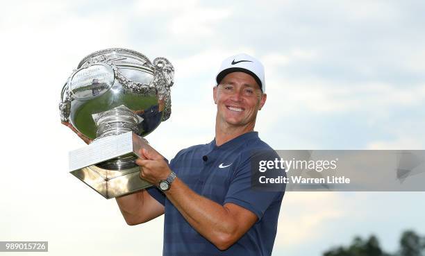 Alex Noren of Sweden celebrates with the trophy after winning the HNA Open de France at Le Golf National on July 1, 2018 in Paris, France.