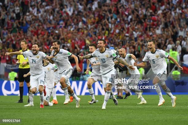 Russia's players celebrate their victory at the end of the Russia 2018 World Cup round of 16 football match between Spain and Russia at the Luzhniki...