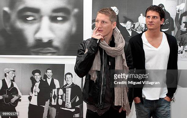 German football players Bastian Schweinsteiger and Mario Gomez attend the Strenesse book presentation 'Die Spieler' by German photographer Ellen von...