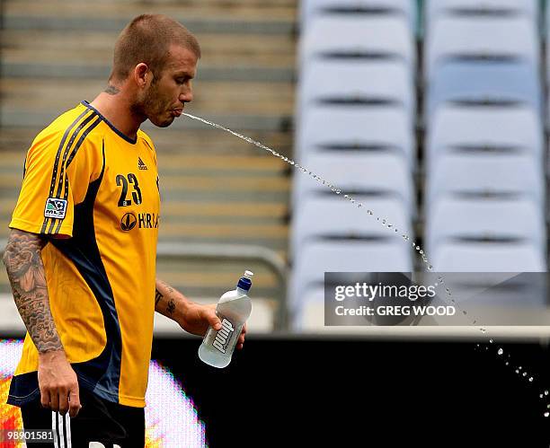 English football superstar David Beckham spits water after taking a drink during training in Sydney, 26 November 2007. Beckham and his new club, the...