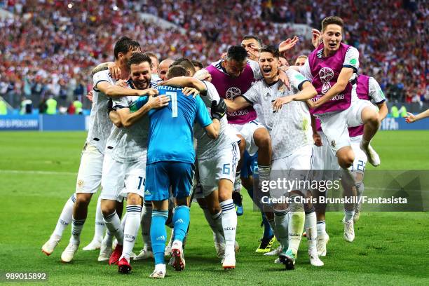 Igor Akinfeev of Russia is congratulated by his team-mates after the penalty shoot-out following the 2018 FIFA World Cup Russia Round of 16 match...