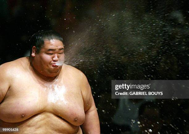 Sumo wrestler spits water to shows what is forbidden in the ring during an exhibition before the start of action on the first day of the Grand Sumo...