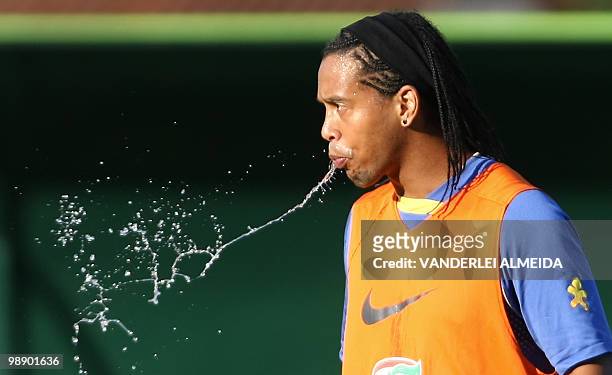 Brazilian footballer Ronaldinho spits water during a training session on September 4 in Teresopolis, Brazil. Brazil will face Chile next September 7h...