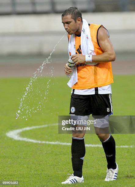 Chelsea football club's midfielder Frank Lampard spits water after a training session in China's southern city of Guangzhou on July 21, 2008. Chelsea...