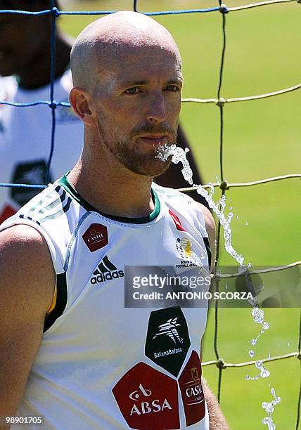 South African national team defender Matthew Booth spits water after a training session of his team on March 11 at Granja Comary in Teresopolis,...