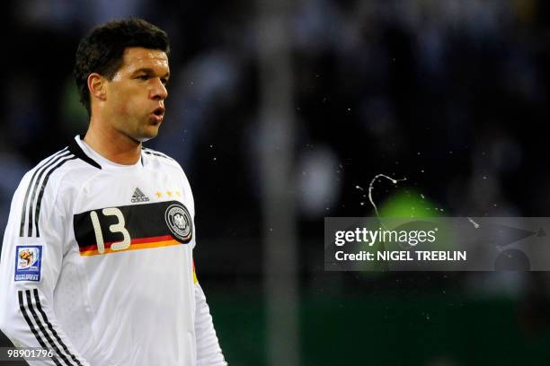 Germany's midfielder Michael Ballack spits during the 2010 World Cup qualifier match Germany vs Finland in the northern German city of Hamburg on...