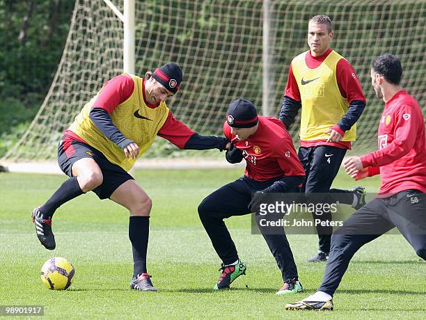 Dimitar Berbatov and Wayne Rooney of Manchester United in action during a First Team Training Session at Carrington Training Ground on May 7 2010 in...