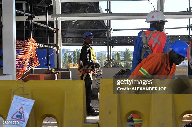 Employees work at Marlboro station built for the Gautrain, South Africa's first high-speed train, in Johannesburg on May 6, 2010. The line will open...