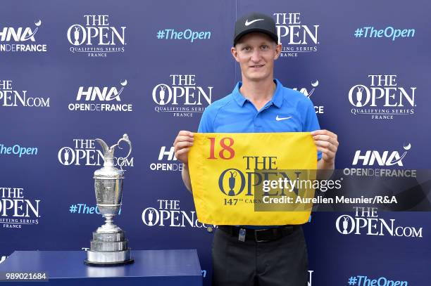 Marcus Kinhult of Sweden poses next to the Claret Jug Trophy after qualifying for the Open during The Open Qualifying Series part of the HNA Open de...