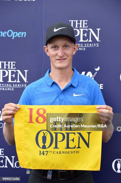 Marcus Kinhult of Sweden poses next to the Claret Jug Trophy after qualifying for the Open during The Open Qualifying Series part of the HNA Open de...
