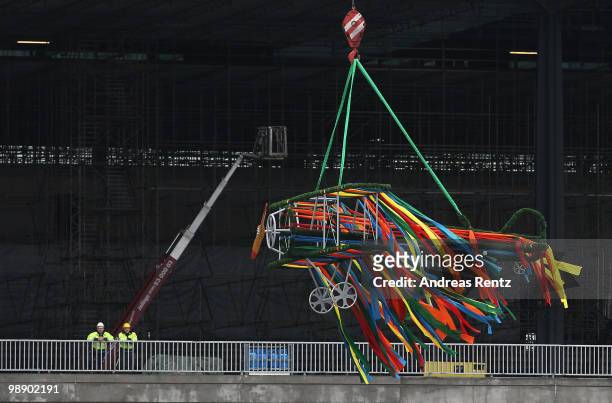 An aircraft shaped crown is lifted by a crane at the main terminal during the roofing ceremony at the new Airport Berlin Brandenburg International...