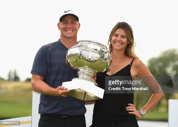 Alex Noren of Sweden and his wife Jennifer pose with the trophy after winning the 2018 HNA Open de France during final round of the HNA Open de...