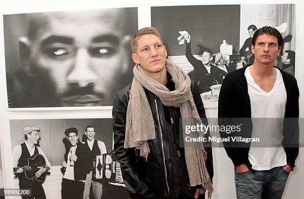 German football players Bastian Schweinsteiger and Mario Gomez attend the Strenesse book presentation 'Die Spieler' by German photographer Ellen von...