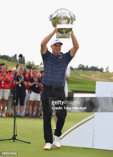 Alex Noren of Sweden lifts the trophy after winning the 2018 HNA Open de France during final round of the HNA Open de France at Le Golf National on...