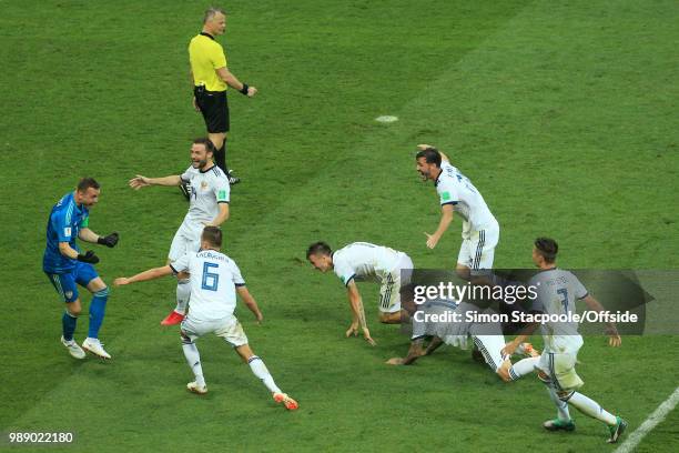 Russia mob Russia goalkeeper Igor Akinfeev after he saves the final penalty and wins them the match during the 2018 FIFA World Cup Russia Round of 16...