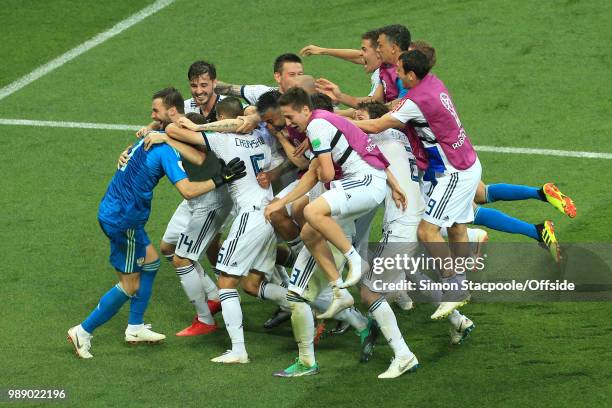 Russia mob Russia goalkeeper Igor Akinfeev after he saves the final penalty and wins them the match during the 2018 FIFA World Cup Russia Round of 16...