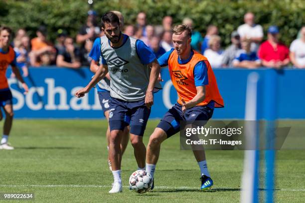 Coke of Schalke and Cedric Teuchert of Schalke battle for the ball during the FC Schalke 04 team presentation on July 1, 2018 in Gelsenkirchen,...