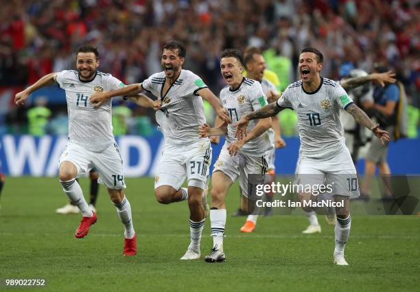 Vladimir Granat , Aleksandr Erokhin, Aleksandr Golovin and Fyodor Smolov of Russia celebrates when they win the penalty shoot out during the 2018...