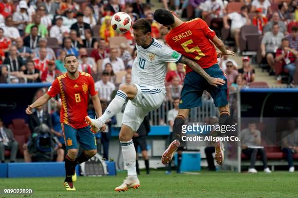 Sergio Busquets of Spain battles Fedor Smolov of Russia during the 2018 FIFA World Cup Russia Round of 16 match between Spain and Russia at Luzhniki...