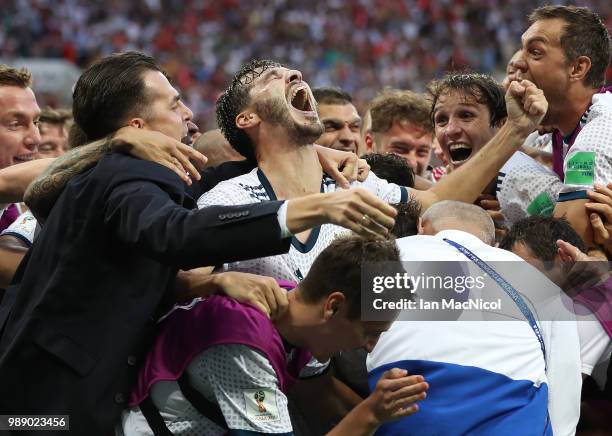 The Russia team celebrate with Aleksandr Erokhin of Russia during the 2018 FIFA World Cup Russia Round of 16 match between Spain and Russia at...