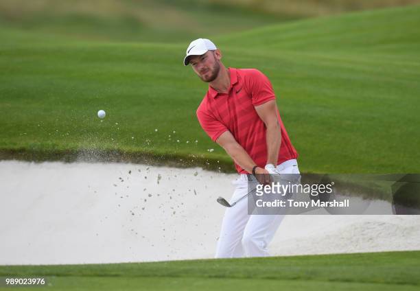 Chris Wood of England chips out of a bunker onto the 18th green during final round of the HNA Open de France at Le Golf National on July 1, 2018 in...