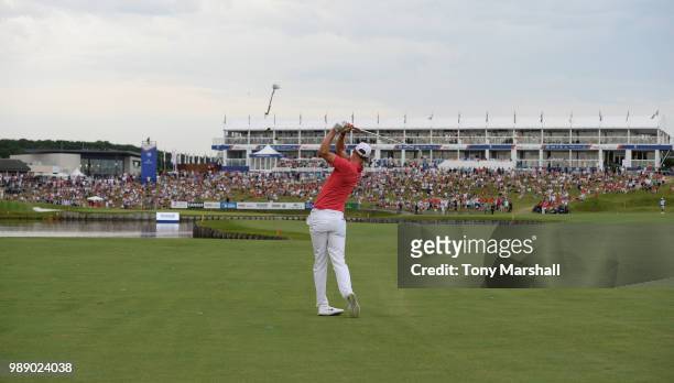 Chris Wood of England plays his second shot onto the 18th green during final round of the HNA Open de France at Le Golf National on July 1, 2018 in...