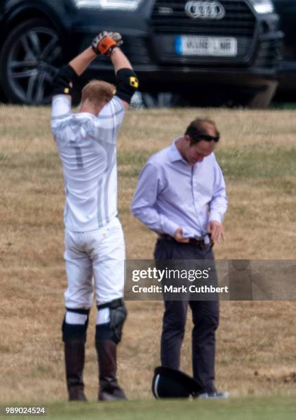 Prince Harry, Duke of Sussex waits for his sunglasses to be cleaned during the Audi Polo Challenge Day 2 at Coworth Park Polo Club on July 01, 2018...