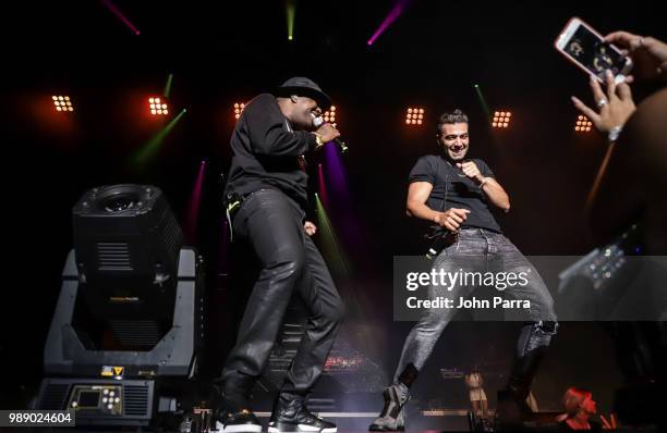 El Micha and Jen Carlos Canela perform on stage during El Micha Concert at Miami Dade Auditorium on June 30, 2018 in Miami, Florida.