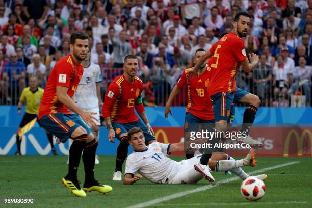 Roman Zobnin of Russia checks Sergio Busquets of Spain during the 2018 FIFA World Cup Russia Round of 16 match between Spain and Russia at Luzhniki...