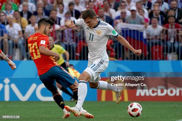 Roman Zobnin of Russia cclashes with Marco Asensio of Spain during the 2018 FIFA World Cup Russia Round of 16 match between Spain and Russia at...