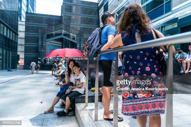 Visitors try to remain cool while waiting in line at the Liberty One Observation Deck in sweltering heat on July 1, 2018 in Philadelphia,...