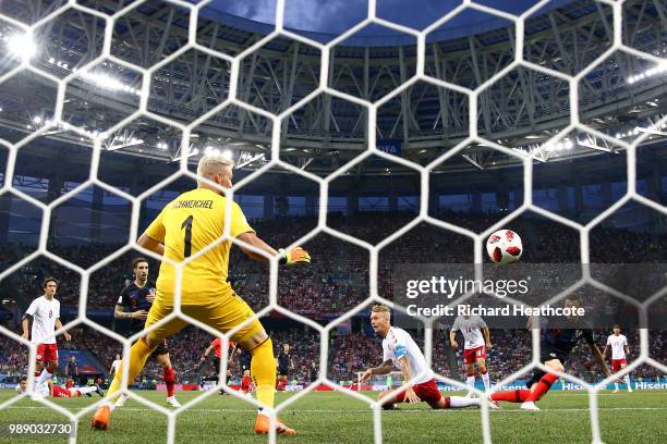 Mario Mandzukic of Croatia scores his team's first goal past Kasper Schmeichel of Denmark during the 2018 FIFA World Cup Russia Round of 16 match...