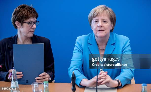 July 2018, Germany, Berlin: German Chancellor Angela Merkel and CDU General Secretary Annegret Kramp-Karrenbauer waiting for the start of a meeting...