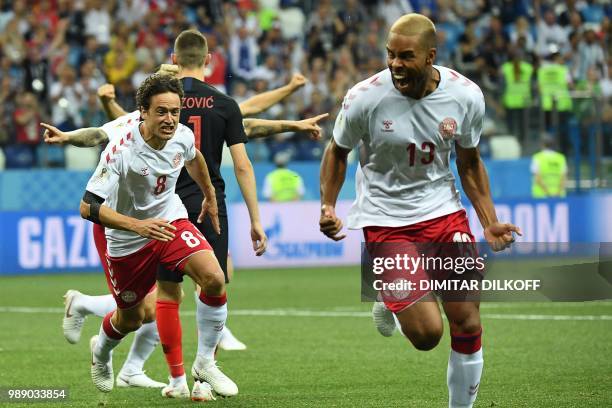 Denmark's defender Mathias Jorgensen celebrates after scoring the opening goal with Denmark's midfielder Thomas Delaney during the Russia 2018 World...