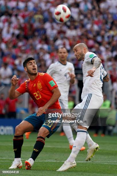 Marco Asensio of Spain battles Fedor Kidriashov of Russia during the 2018 FIFA World Cup Russia Round of 16 match between Spain and Russia at...