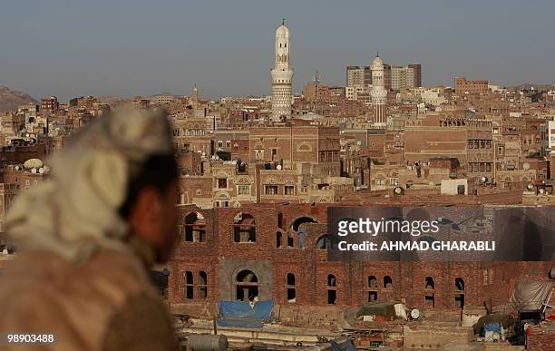 Yemeni man looks towards Sanaa's Old City on January 15, 2010. An air strike on an Al-Qaeda in the Arabian Peninsula position in north Yemen killed...