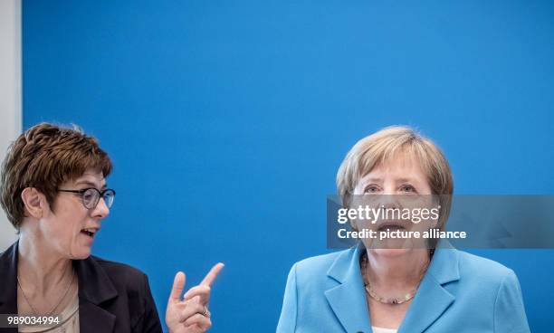 July 2018, Germany, Berlin: German Chancellor Angela Merkel and CDU General Secretary Annegret Kramp-Karrenbauer waiting for the start of a meeting...