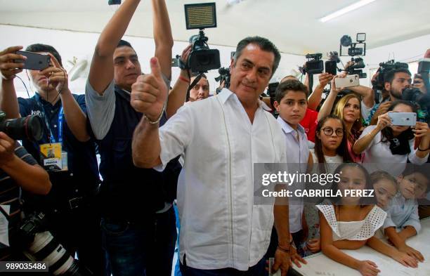 Mexico's presidential independent candidate Jaime "El Bronco" Rodriguez Calderon gives his inked thumb up after casts his vote during general...