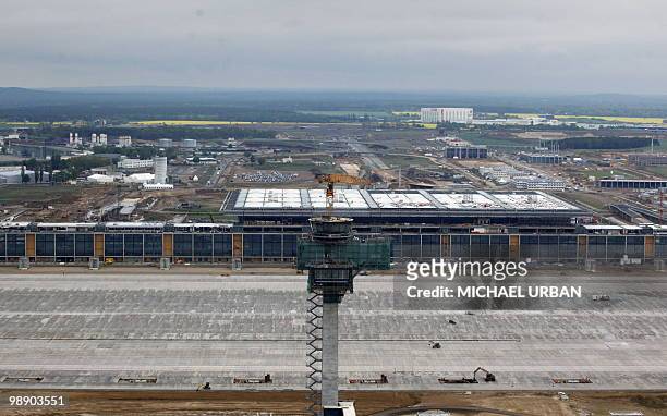 Aerial view taken on May 7, 2010 shows the tower and the main terminal of the Berlin-Brandenburg International airport during a traditional "topping...