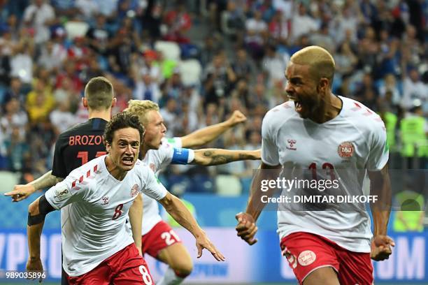 Denmark's defender Mathias Jorgensen celebrates with midfielder Thomas Delaney after scoring the opening goal during the Russia 2018 World Cup round...